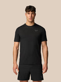 Male model wearing a black Apex Training T-Shirt in a simple studio setting