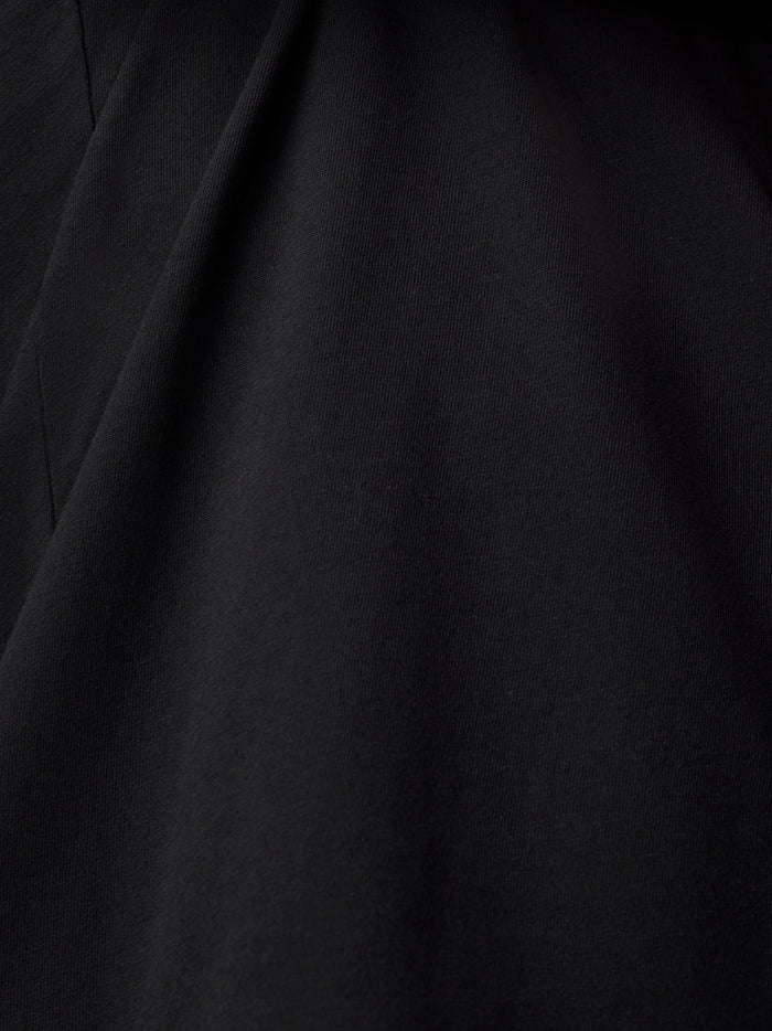 Close-up of black fabric showing texture and drape of the T shirt