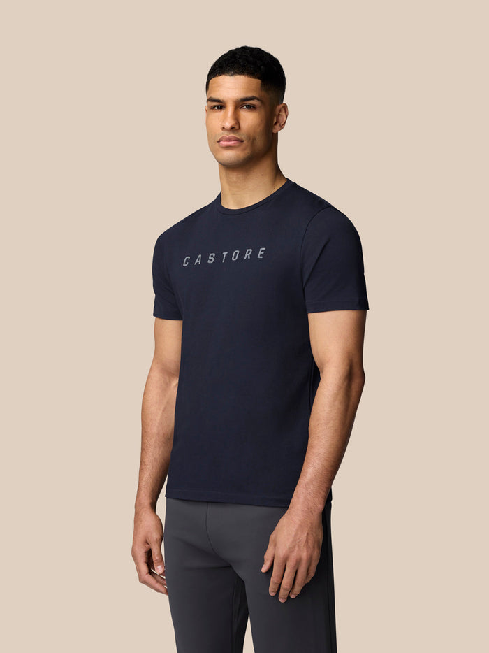 Male model wearing midnight navy Castore graphic T shirt with chest logo in a front product shot