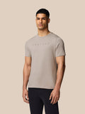 Male model wearing beige Rock Grey Castore graphic crew neck short sleeve T-shirt, front view.