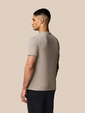 Back view of beige Rock Grey Castore graphic short sleeve T-shirt on a male model.