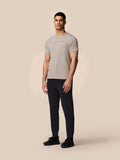 Full-length shot of a man wearing Rock Grey Castore graphic T-shirt with regular fit and drop shoulders, paired with black joggers and sneakers