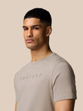 Close-up of a man wearing Rock Grey Castore graphic T-shirt highlighting the chest logo and crew neck