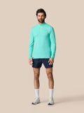 Full-body view of a man in light aqua Zone Training 1/4 Zip Top with navy shorts.