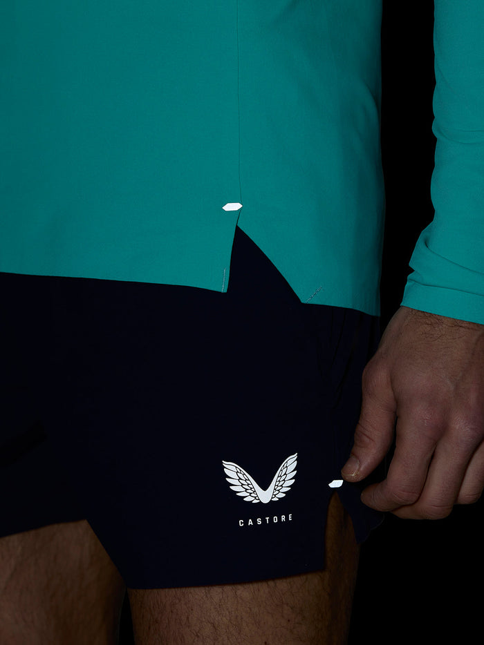 Close-up of light aqua Zone Training 1/4 Zip Top hem with bonded edge and reflective accent.