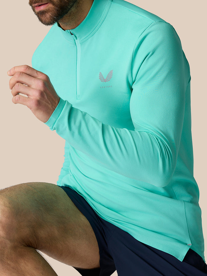 Light aqua Zone Training 1/4 Zip Top on a model with high neck and front zipper