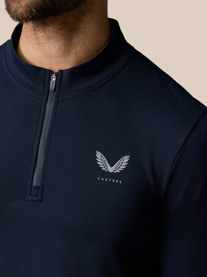 Close up of midnight navy Zone Training 1/4 Zip Top showing front zip collar and Castore logo on chest