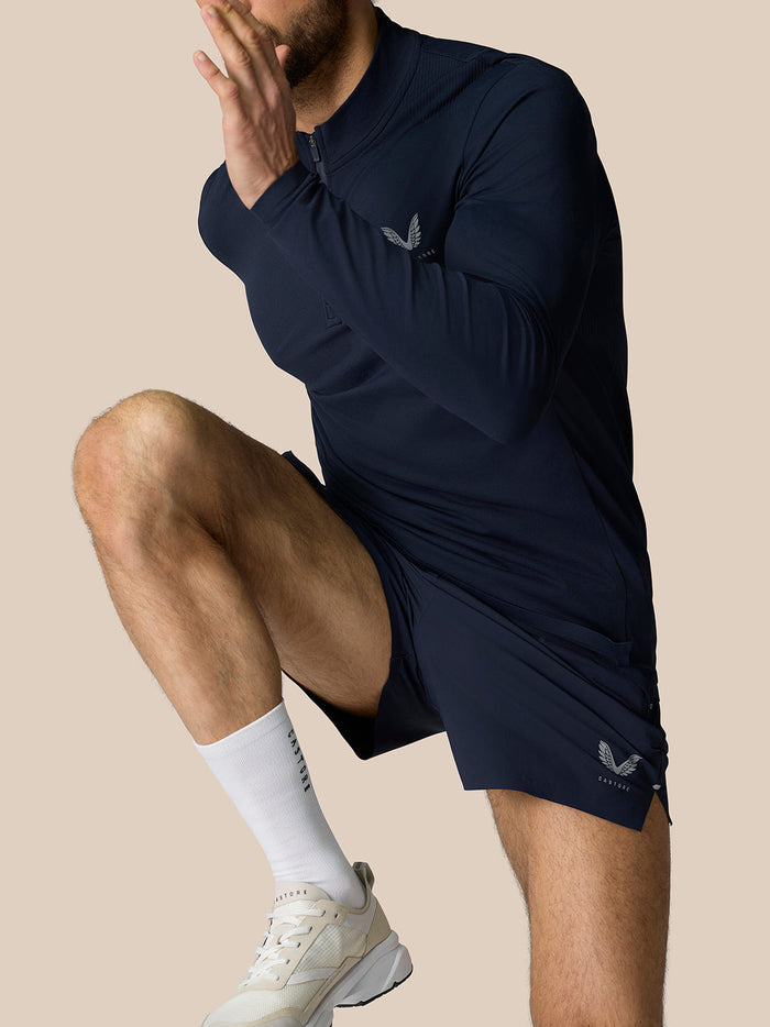 Zone Training 1/4 Zip Top in Midnight Navy worn by a model; high neck with a quarter zip and reflective branding