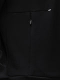 Close-up of the back center zipper on a black crew neck sweatshirt with a small logo near the shoulder.