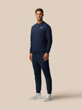 Male model wearing navy Travel Lifestyle Sweatshirt with logo on the chest and a zip pocket
