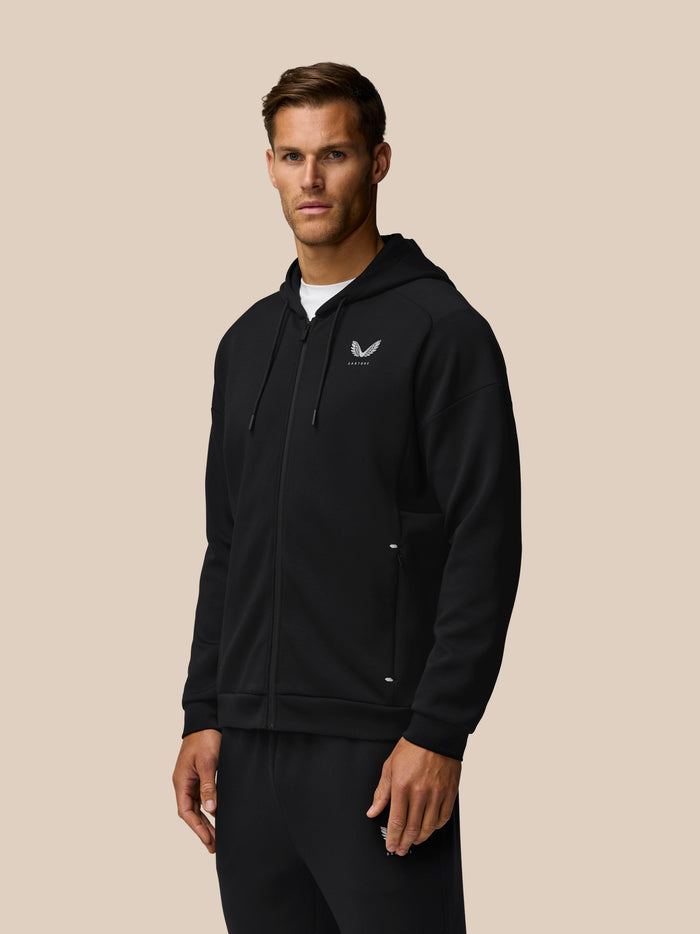 Black Travel Zip Hoodie worn by a model with front zipper and left chest logo