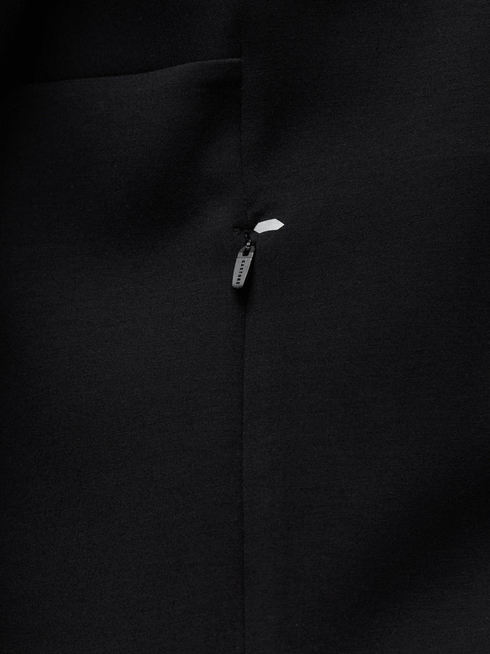 Close-up of black Travel Zip Hoodie chest area with visible zipper pull and Castore branding.