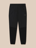 Full view of black Flex Winterised Woven Joggers with elastic cuffs and Castore logo on the left thigh.