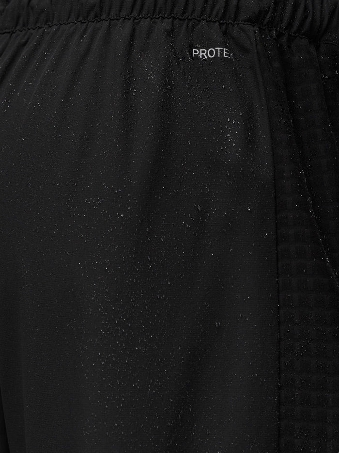 Close-up of black ProTek fabric with waistband detail on Flex Winterised Woven Joggers.