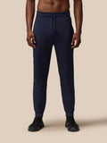 Male model wearing navy Flex Lifestyle Thermo Pant with drawstring waist and tapered cuffs.