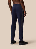 Back view of navy Flex Thermo Pant with side panel stripe and cuffed ankles.
