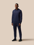 Male model in navy Castore Flex Thermo Pant set with logo on chest and left leg.
