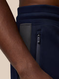 Close-up of navy Flex Thermo Pant side pocket with a zip closure and dark zipper.