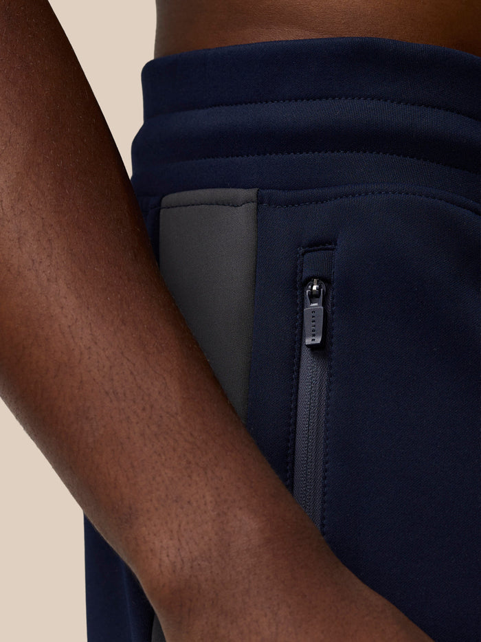 Close-up of navy Flex Thermo Pant side pocket with a zip closure and dark zipper.