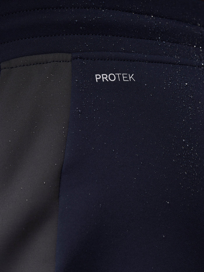 Close-up of navy fabric with ProTek branding and water droplets.