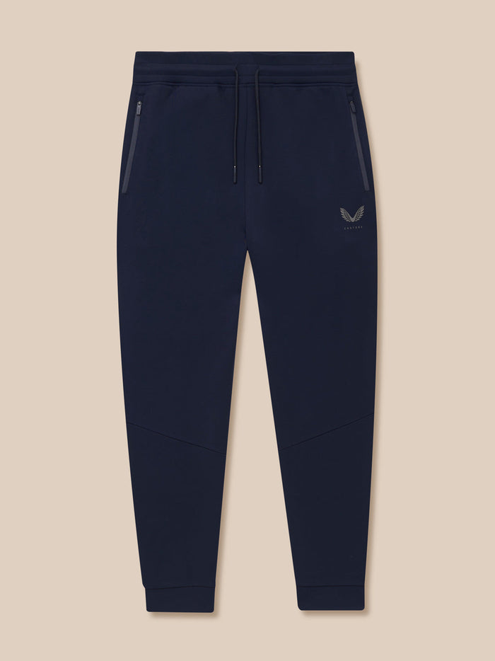 Front view of navy Flex Thermo Pant with zippered side pockets and Castore logo on left leg.