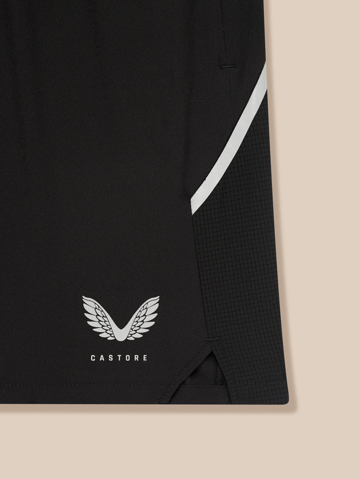Back view of black Apex shorts with elastic waistband and white side stripe near hem and Castore logo