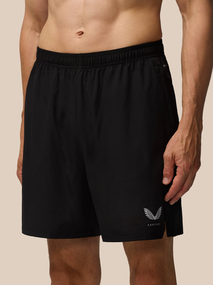 Back view of black Apex 6-Inch Shorts with elastic waistband and Castore logo on the leg