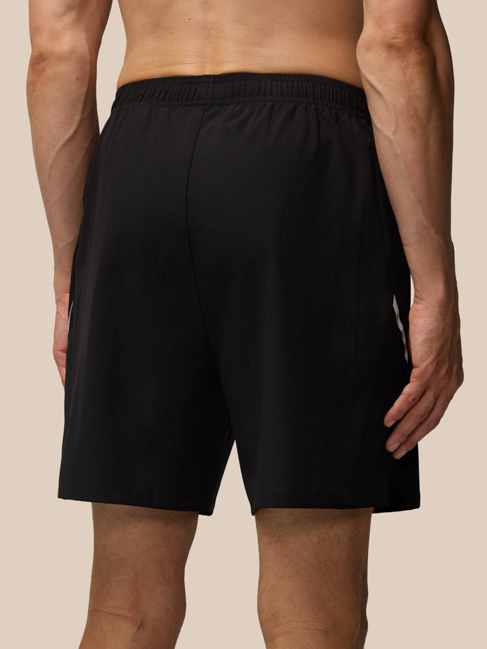 Close-up of black Apex 6-Inch Shorts showing zip pocket and Castore logo on the left leg