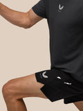 Close-up of a male model in a black athletic top with Castore logo and black shorts.