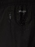 ProTek zipper detail on black shorts with water droplets.