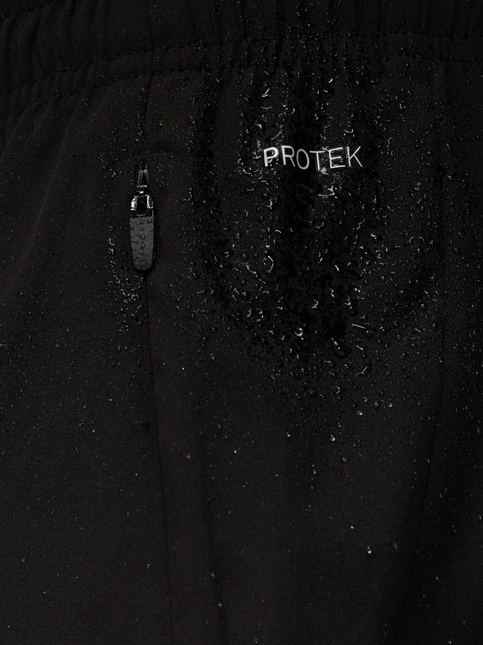 ProTek zipper detail on black shorts with water droplets.