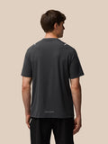 Back view of a man wearing gunmetal Apex Training T Shirt showing reflective shoulder details and Castore branding at the back hem.