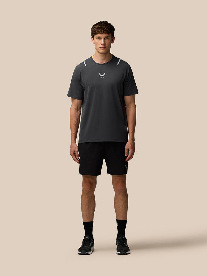Front view of a man wearing Gunmetal/Silver Reflective Apex Training T-Shirt with reflective shoulder accents.
