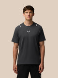 Front view of a man wearing Apex Training T Shirt in gunmetal with reflective shoulder details and a center chest Castore logo.