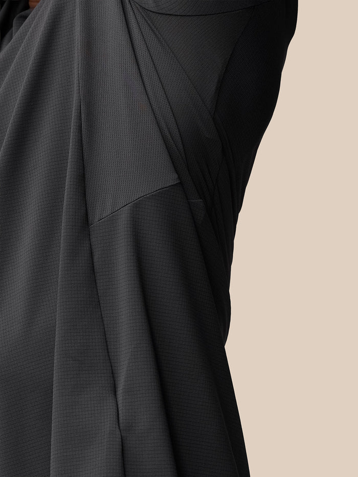 Close up of the Apex Training T Shirt fabric showing a mesh panel and Castore wordmark at back hem.