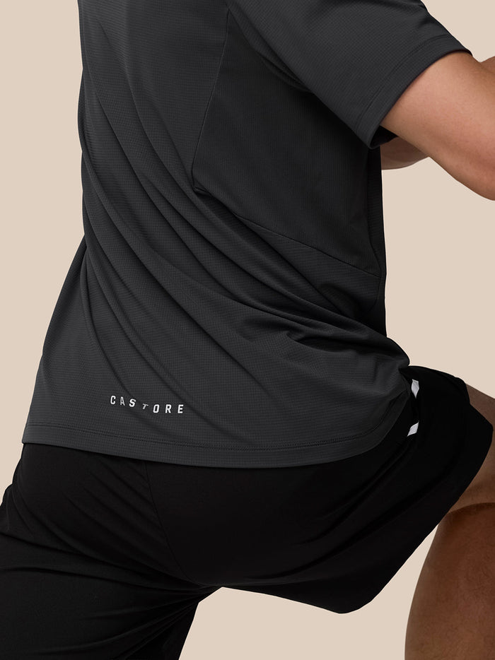 Front view of model wearing Apex Training T Shirt with center chest Castore logo and reflective shoulder details.