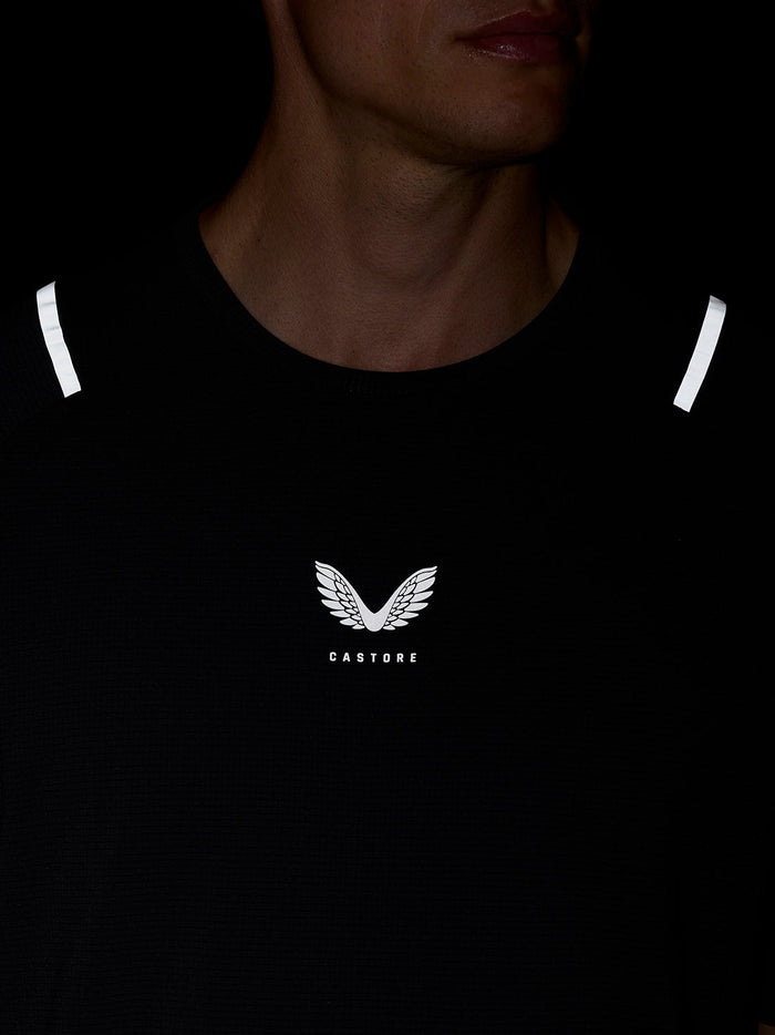 Close up of black Apex Training T Shirt showing Castore logo at the center chest and reflective shoulder hits.