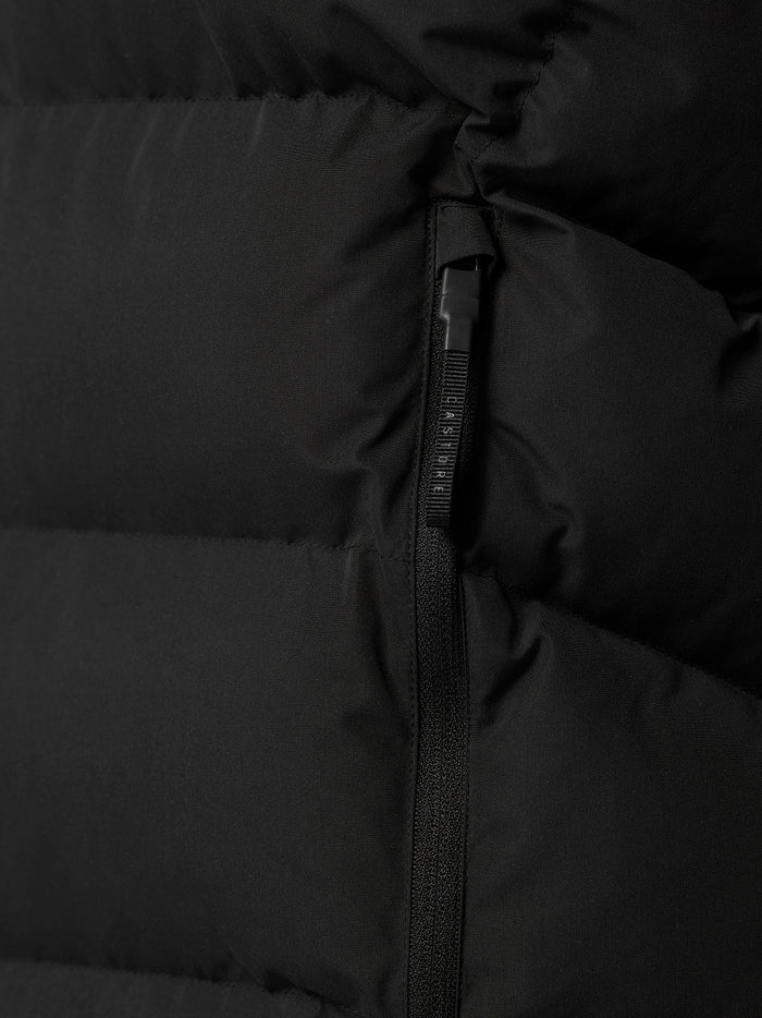 Close up of black puffer fabric highlighting stitched panels and matte finish