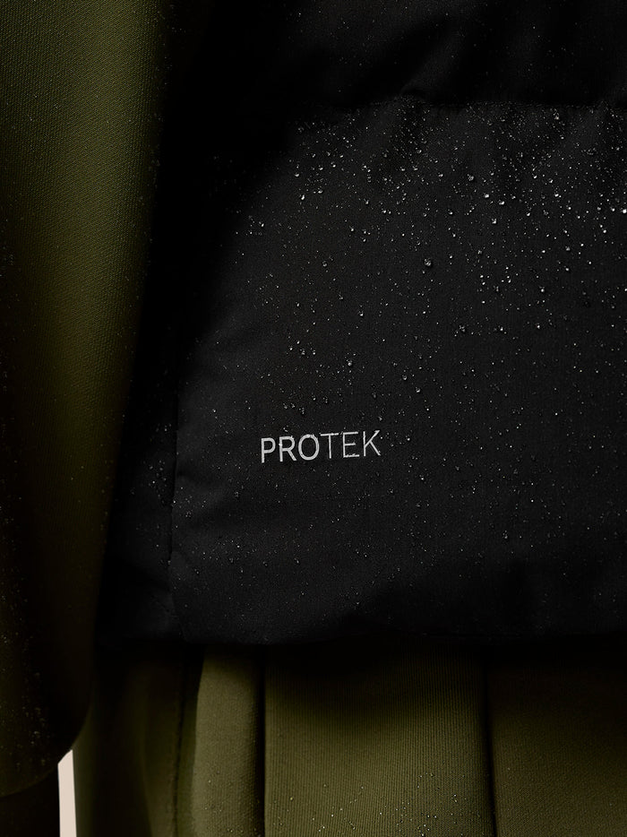Close-up of black ProTek puffer gilet fabric with water droplets