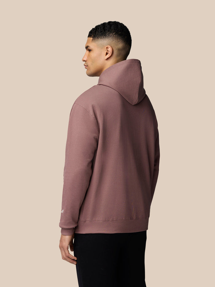 Back view of model in mauve Adapt Lifestyle Hoodie with hood down and sleeve logo visible.