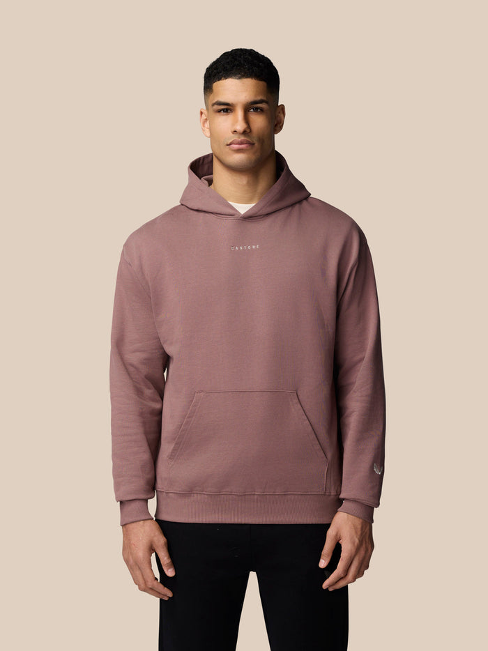 Male model wearing mauve Adapt Lifestyle Hoodie with front pocket and relaxed fit