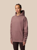 Model wearing Adapt Lifestyle Hoodie Mauve in three-quarter view highlighting the relaxed silhouette.