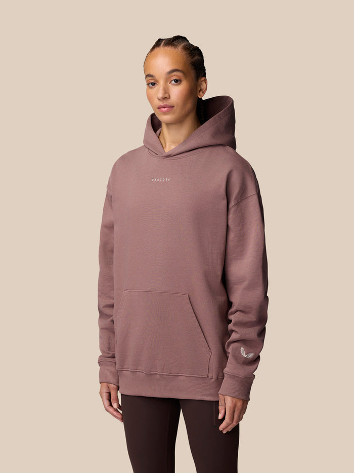 Model wearing Adapt Lifestyle Hoodie Mauve in three-quarter view highlighting the relaxed silhouette.