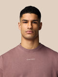 Male model wearing mauve Adapt Lifestyle Sweatshirt with crew neck and small front Castore logo