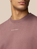 Close-up of mauve Adapt Lifestyle Sweatshirt showing Castore logo on the chest.