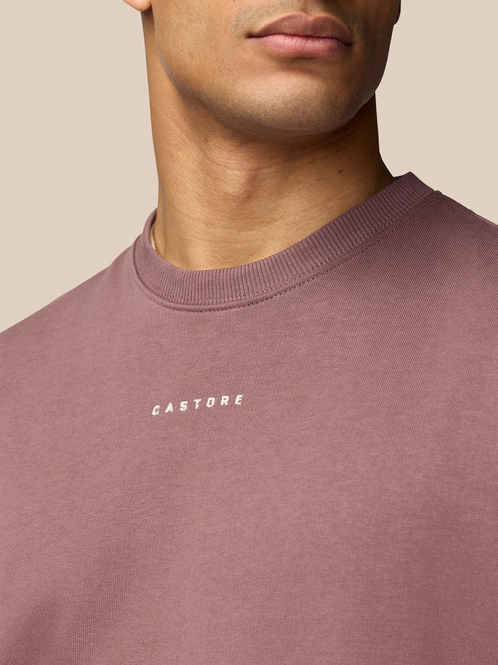 Close-up of mauve Adapt Lifestyle Sweatshirt showing Castore logo on the chest.