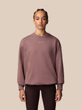 Model wearing mauve Adapt Lifestyle Sweatshirt with oversized silhouette and embroidered Castore logo on chest.