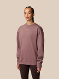 Model wearing mauve Adapt Lifestyle Sweatshirt in an oversized fit with a small chest logo and left arm wing emblem.