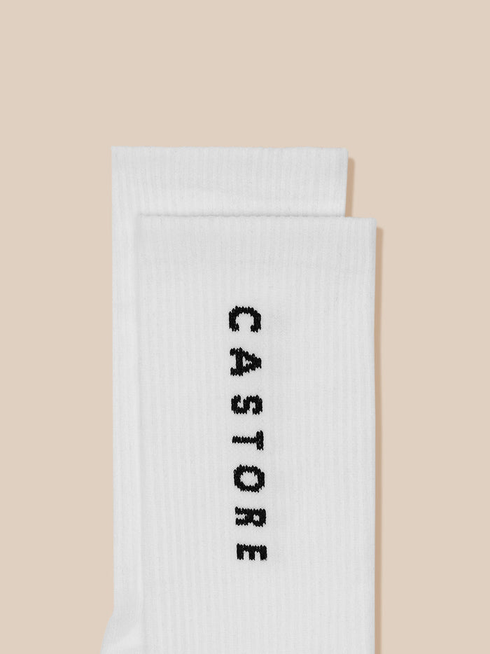 White ribbed crew sock folded with Castore branding printed vertically.
