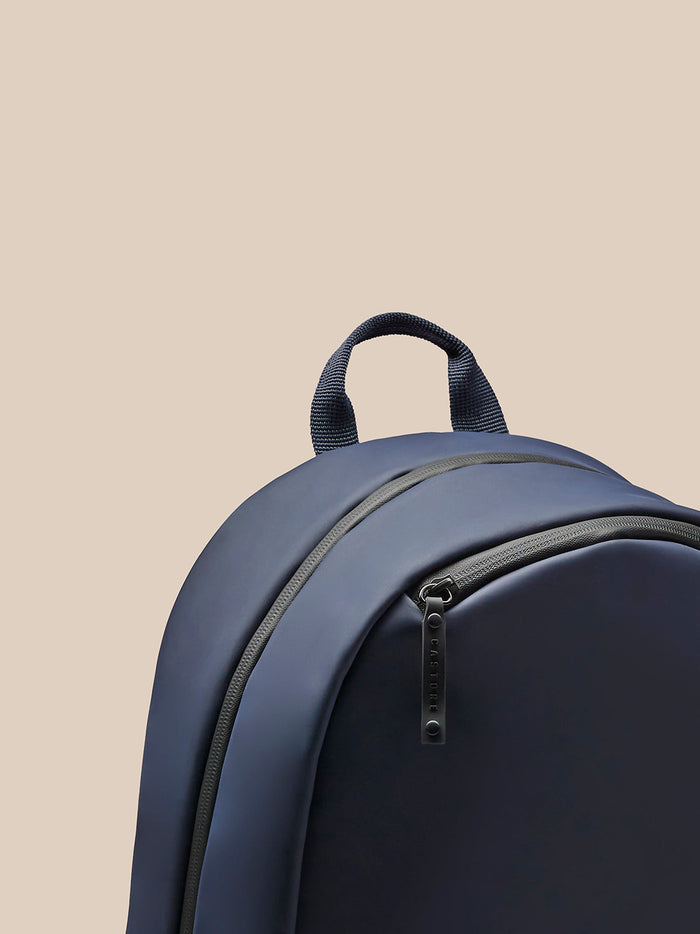 Navy Active Small Backpack close up showing top handle and zipper.